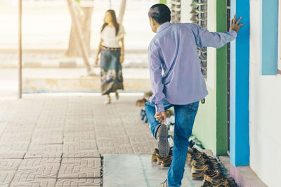 Rear view of people walking outdoors