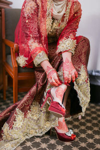 Low section of woman sitting on floor