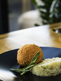 Close-up of stuffed cutlet with rice served in plate
