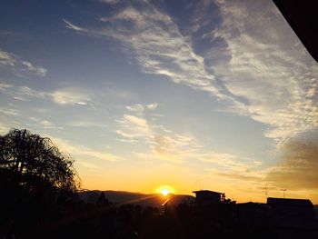 Silhouette of built structure at sunset