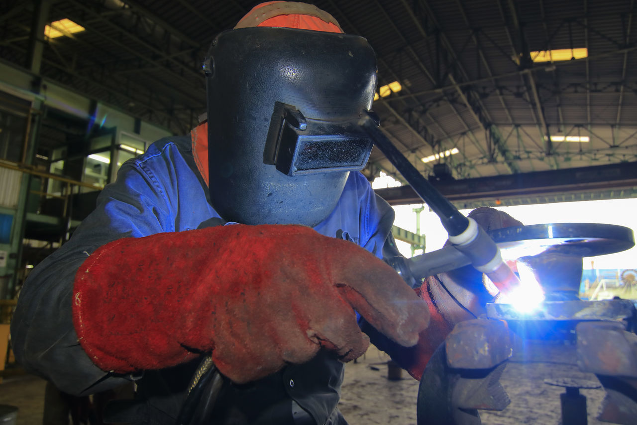 PEOPLE WORKING ON METAL IN KITCHEN