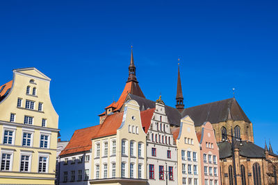 Low angle view of historic building against clear blue sky