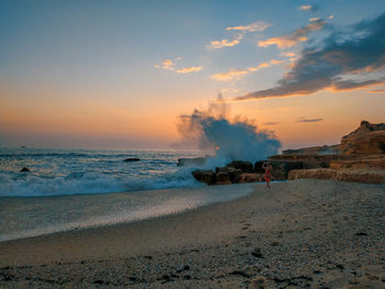 Scenic view of beach against sky during sunset