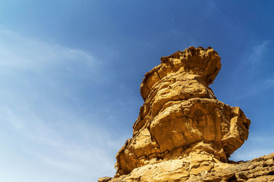 Impressive solitary rock with eolian erosion marks in the desert of wadi rum, jordan