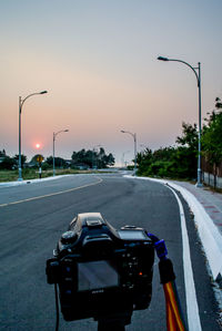 Camera on empty road at sunset