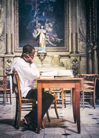 Man sitting on chair at table