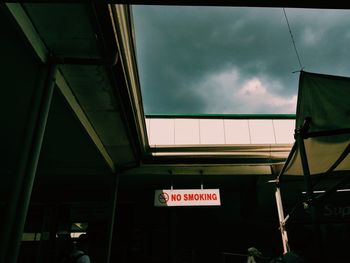 Low angle view of sign against sky at dusk