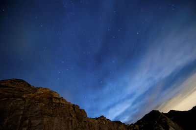 Low angle view of mountain against sky at night