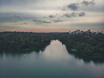 Scenic view of river against sky at sunset