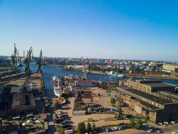 High angle view of buildings against clear blue sky