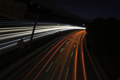 High angle view of light trails on highway at night