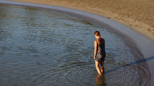 High angle view of woman walking towards river