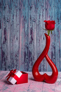 Close-up of red rose hanging on wall