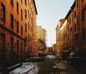 Street amidst buildings against sky in city