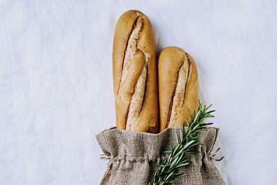 High angle view of bread on table against white background