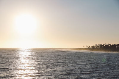 Scenic view of sea against clear sky during sunset