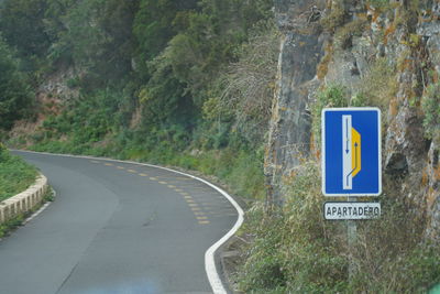 Road sign by trees