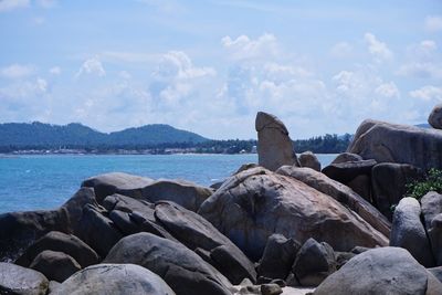 Rocks by sea against sky