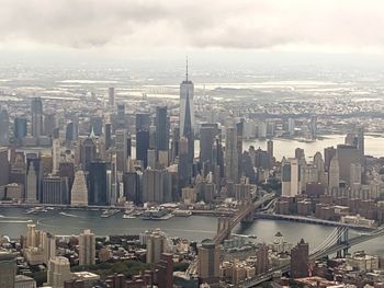 Aerial view of modern buildings in city against sky