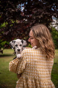 Rear view of woman with dog on field