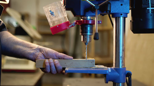 Cropped hand of man working in factory