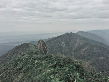 Scenic view of mountain against cloudy sky