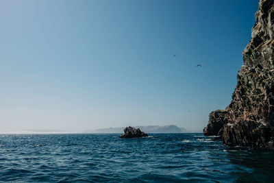 Scenic view of sea against clear blue sky