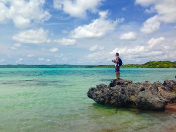 Rear view of man standing on beach