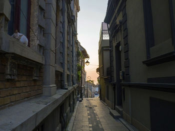 Narrow street amidst buildings against sky