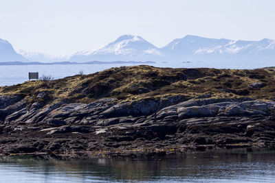 Scenic view of sea and mountains against sky