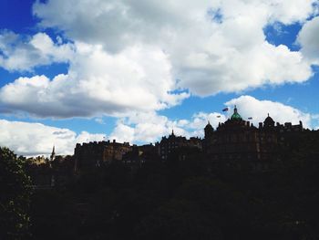 Buildings against cloudy sky