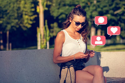 Young woman using mobile phone outdoors