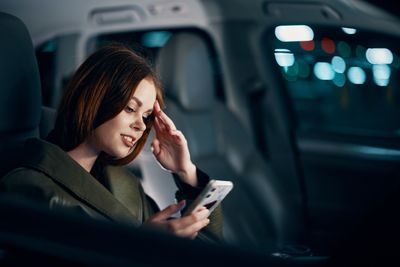 Young woman sitting in car