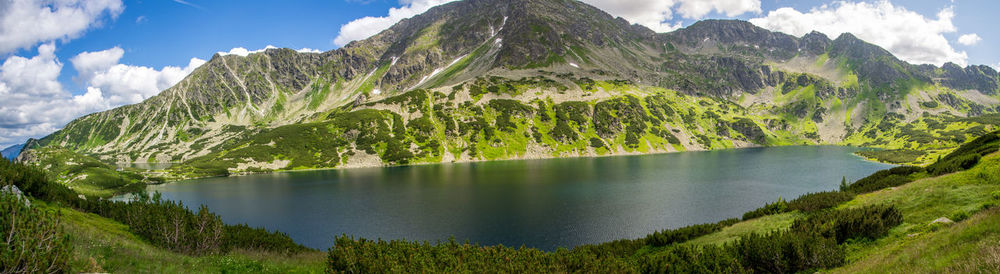 Scenic view of lake and mountains against sky