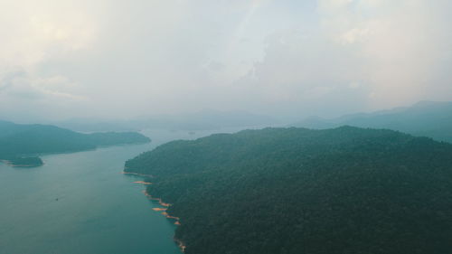 Scenic view of sea and mountains against sky