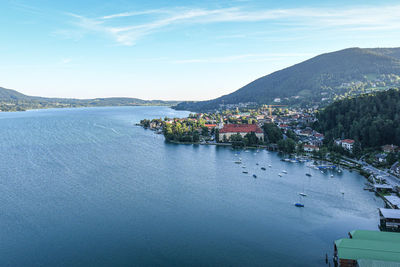 High angle view of town by sea against sky