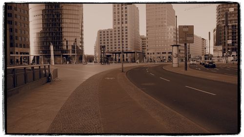 City street and buildings against sky