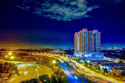 High angle view of city lit up at night