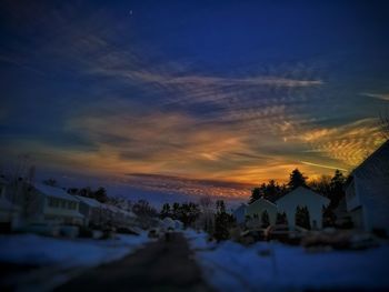 Houses against sky during winter