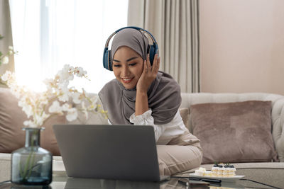 Young woman using laptop at home