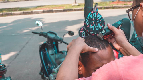 Midsection of woman riding bicycle on road in city