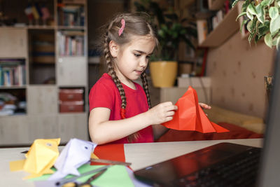 Cute girl doing craft at home