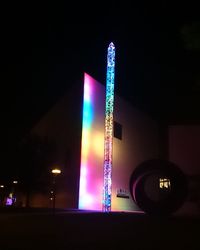 Low angle view of illuminated tower at night