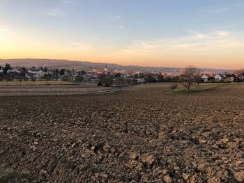 Scenic view of field against sky during sunset