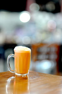 Close-up of coffee cup on wooden table