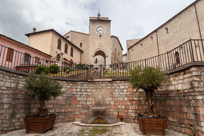 The tower with the clock at the top of the steps in monteleone di spoleto, umbria