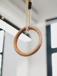 Close-up low angle view of gymnastic ring hanging in gym
