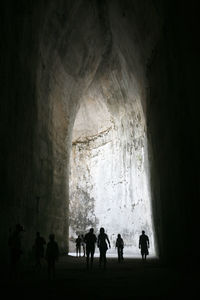 Silhouette people in cave