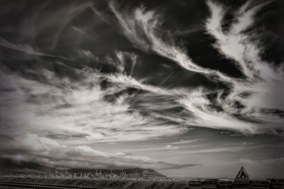 Panoramic view of city against dramatic sky