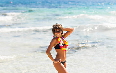 Portrait of woman standing on beach